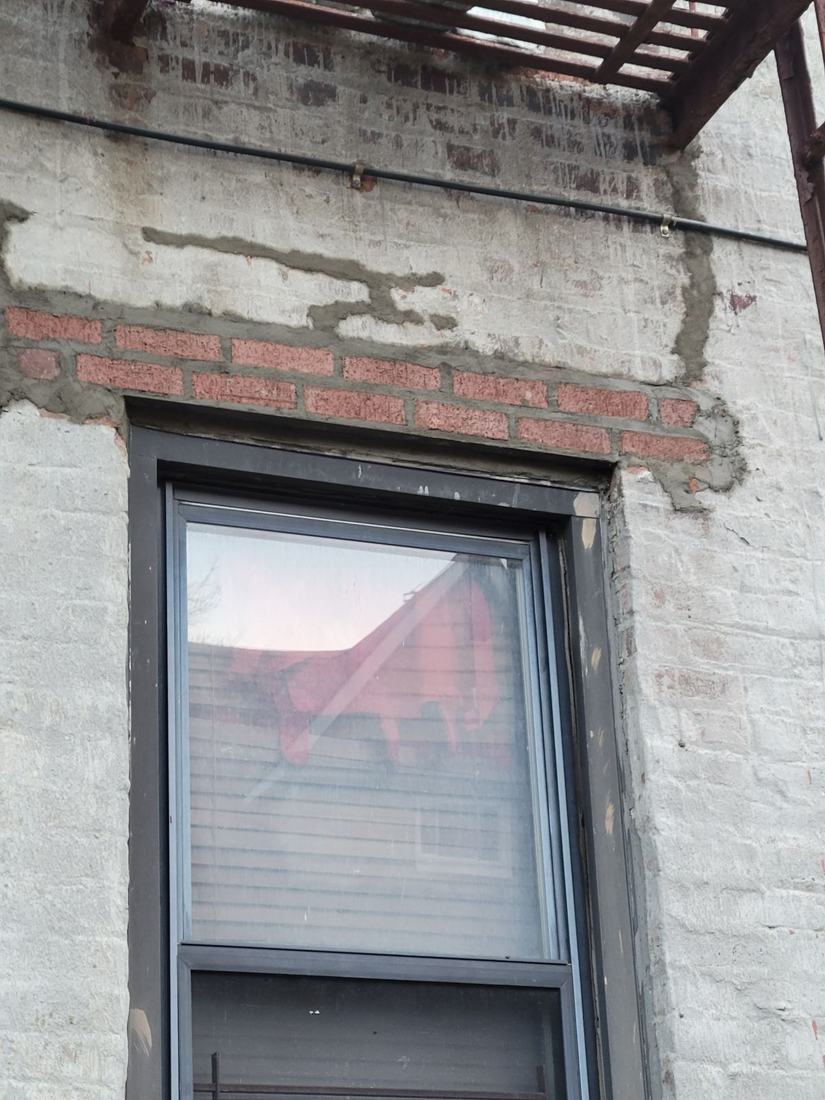 Repaired window lintel and brick after restoration