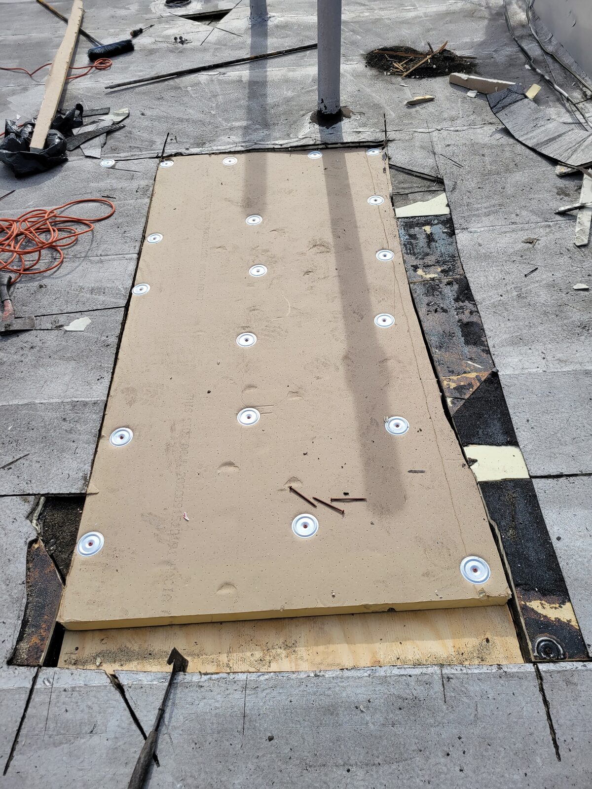New insulation board fastened over repaired roof deck, Harlem, Manhattan