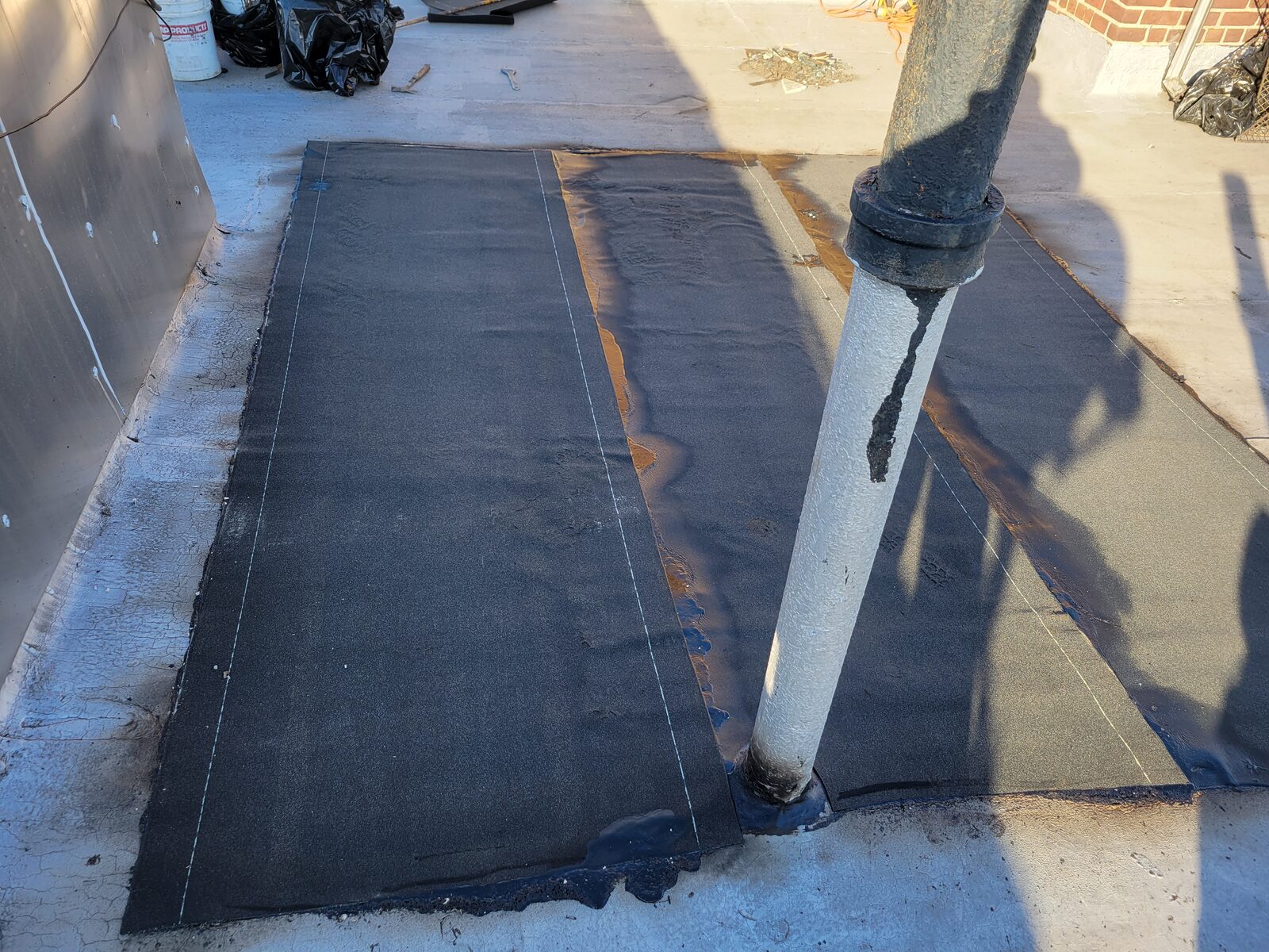 Modified bitumen membrane installed around roof pipe penetration, Harlem, Manhattan
