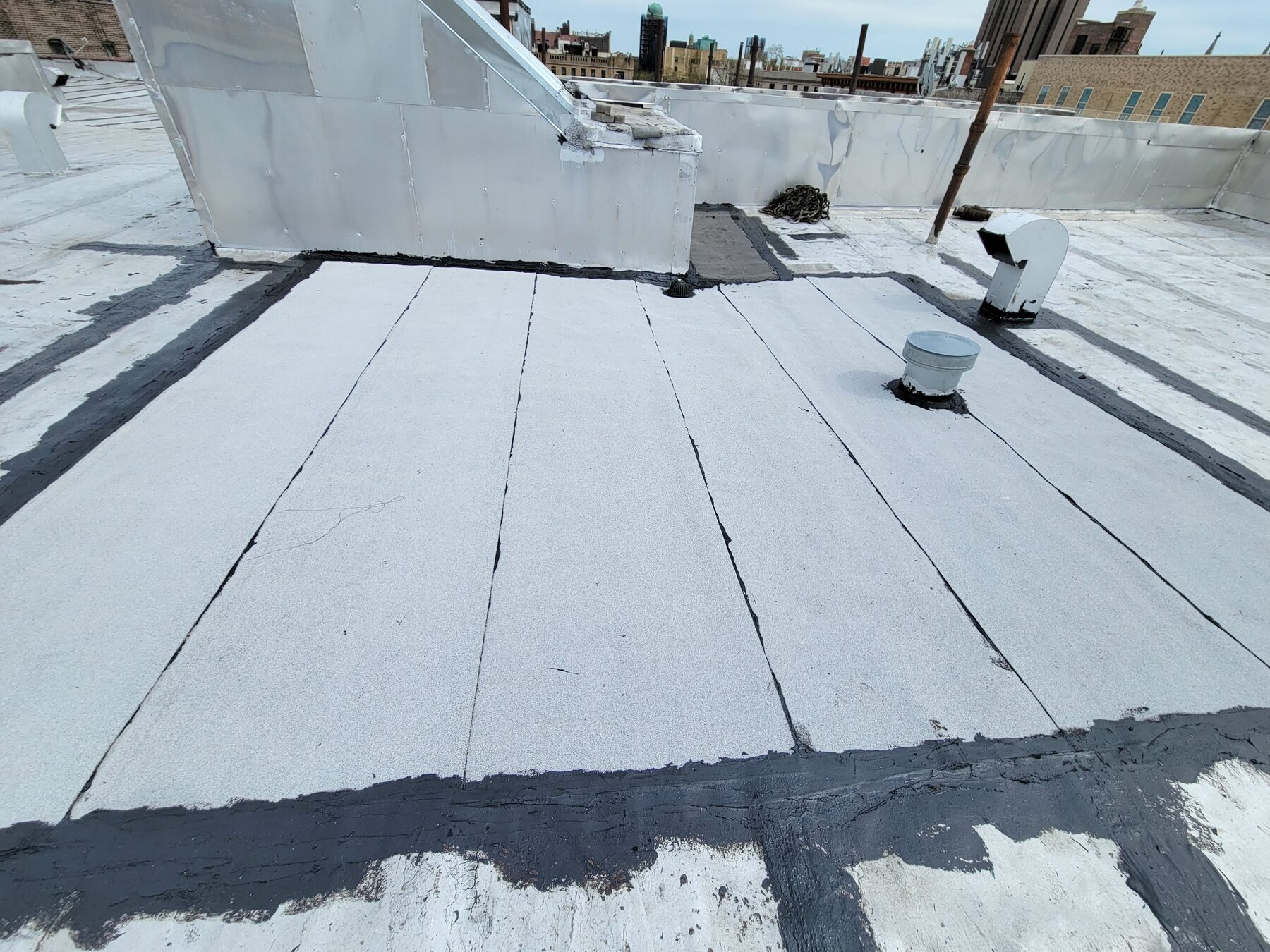 Completed roof repair with reflective coating for a property management client, Inwood, Manhattan
