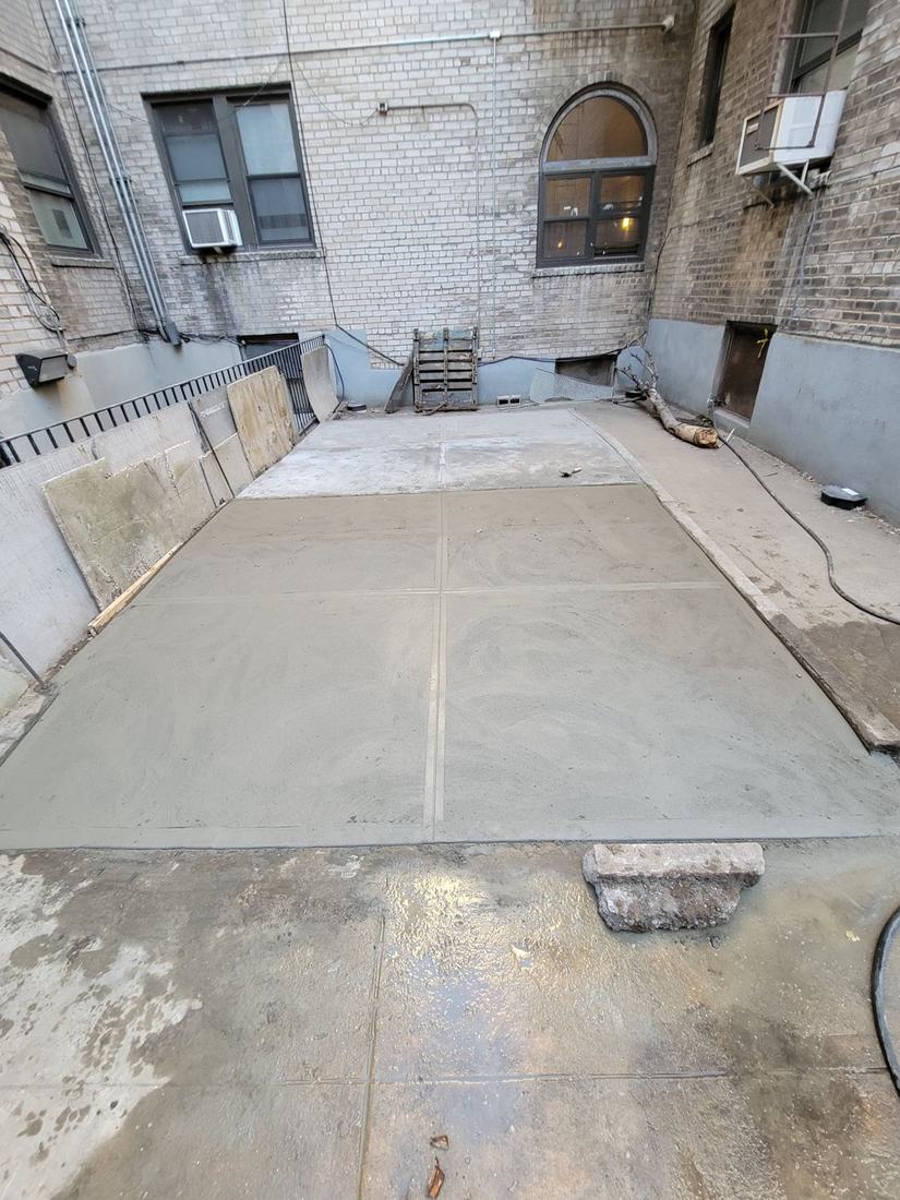 Finished poured concrete courtyard slab, NYC