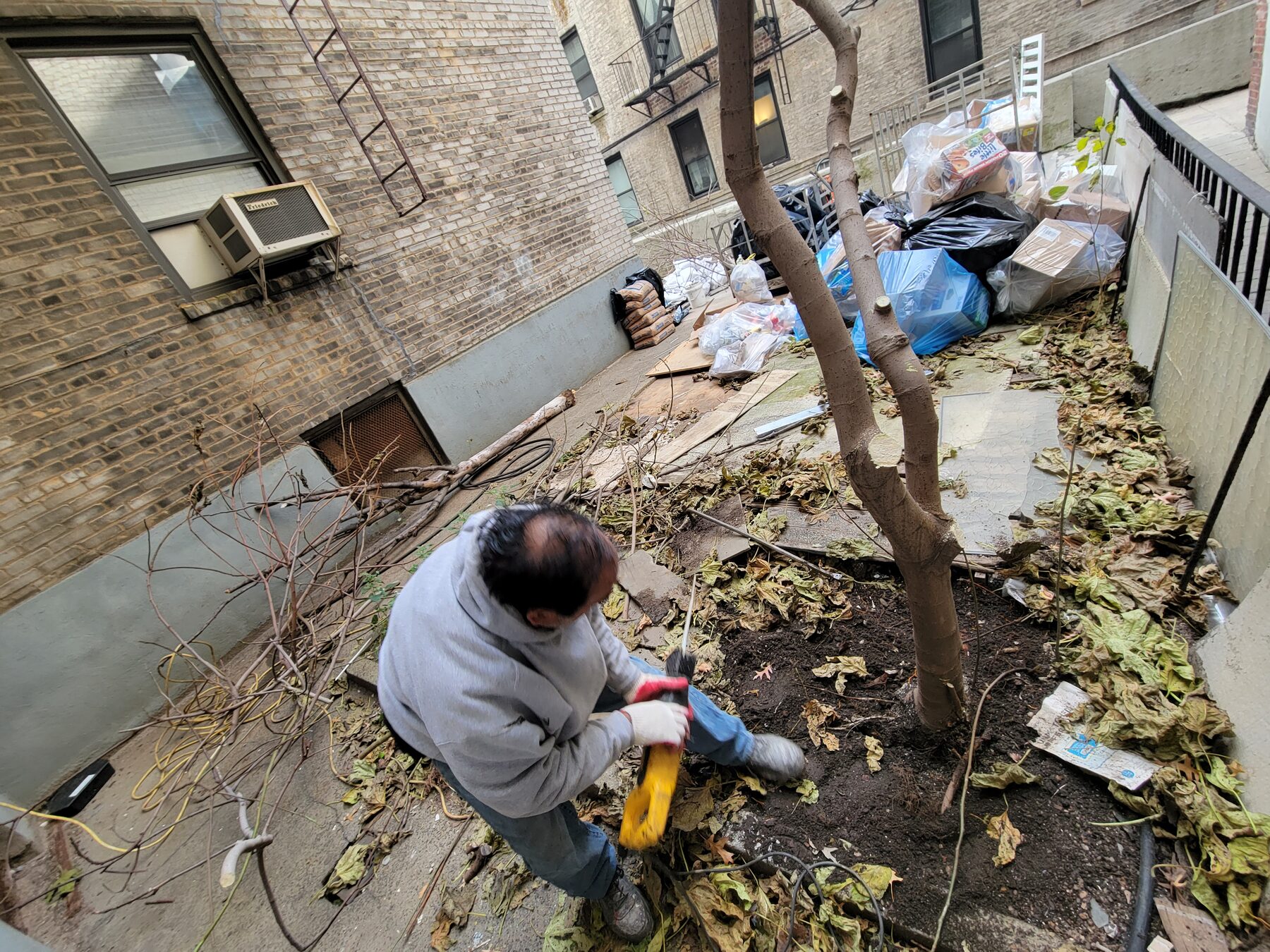 Crew clearing debris before concrete demolition, Astoria, Queens