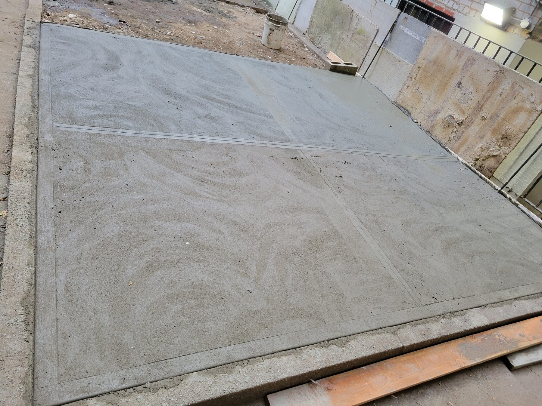 Fresh concrete poured for new courtyard slab, Astoria, Queens