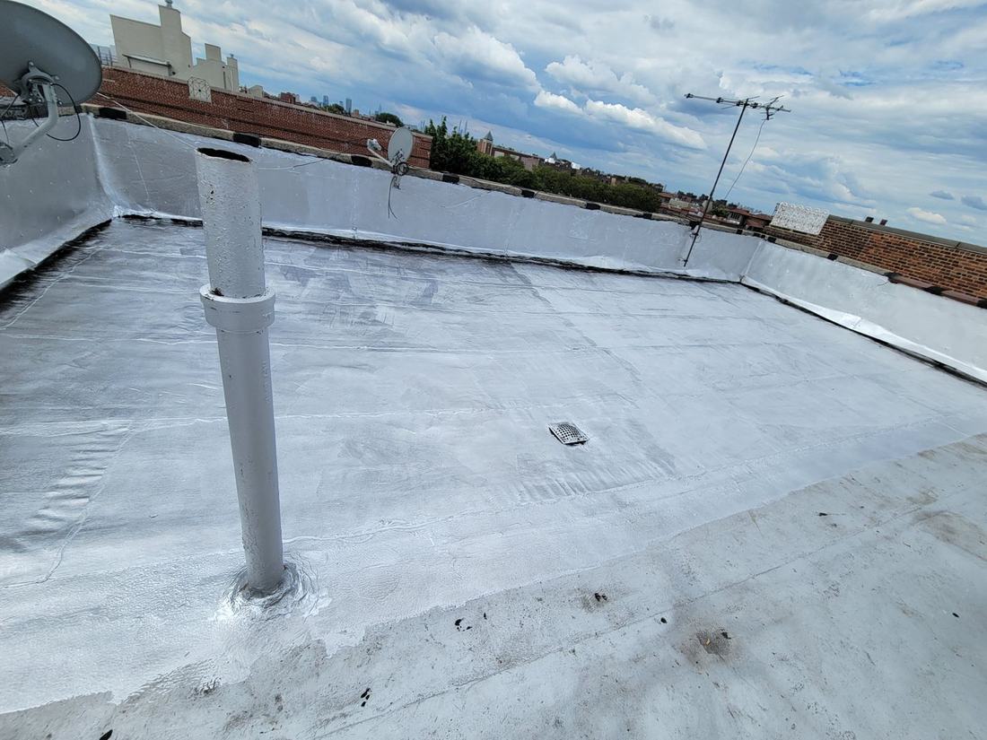 Finished reflective roof membrane with parapet flashing